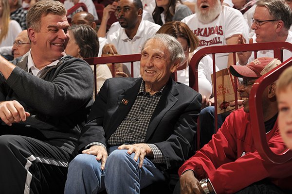 Former Arkansas basketball coach Eddie Sutton, center, talks with former players Joe Kleine, left, and Darrel Walker, right, during a game between Arkansas and Kentucky on Thursday, Jan. 21, 2016, at Bud Walton Arena in Fayetteville. 