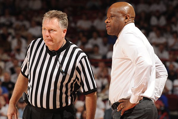 Arkansas coach Mike Anderson speaks to game official Karl Hess against Kentucky Thursday, Jan. 21, 2016, during the second half of play in Bud Walton Arena in Fayetteville.