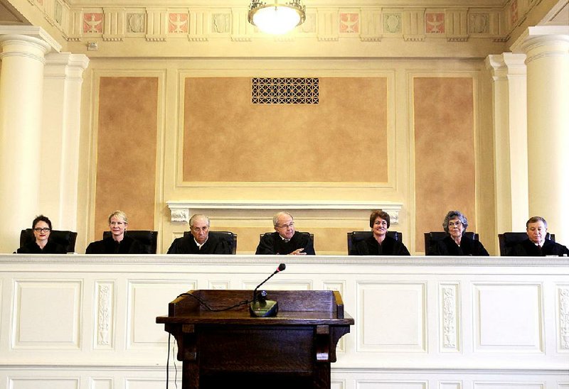 Arkansas Supreme Court Justices (from left) Rhonda Wood, Courtney Goodson, Paul Danielson, Howard Brill, Karen Baker, Josephine Hart and Robin Wynne. Brill is chief justice.