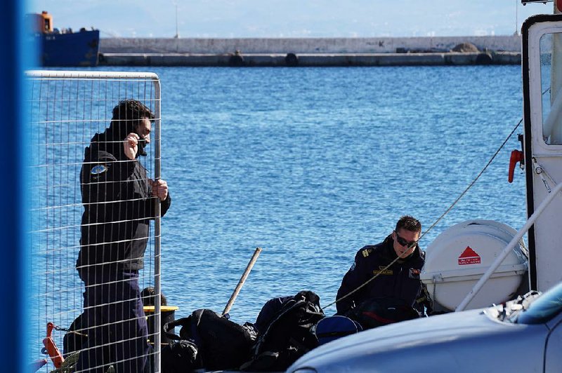 Greek coast guard members prepare for a rescue mission Friday at the island of Kalymnos after a boat sank off the nearby islet of Kalolimnos. 
