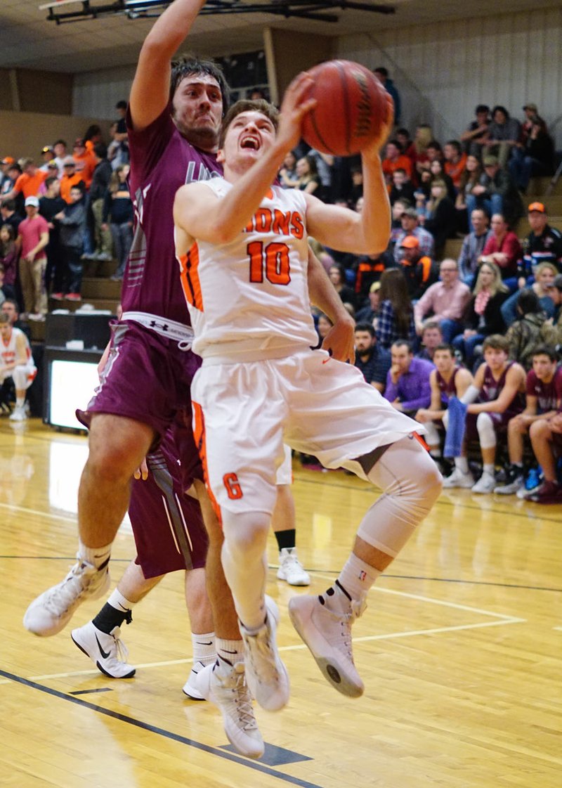 Trace Crawford, Gravette senior, shoots Friday while Lincoln’s Garrett Blankenship guards in Gravette.