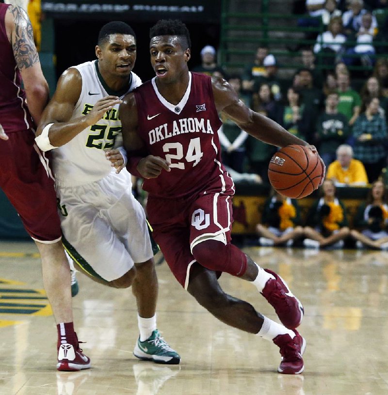 Oklahoma guard Buddy Hield (24) drives to the basket while Baylor guard Al Freeman (25) tries to work around a screen during the second half of the top-ranked Sooners’ 82-72 victory over the No. 13 Bears on Saturday in Waco, Texas. Hield scored 14 of his 19 points in the second half. 