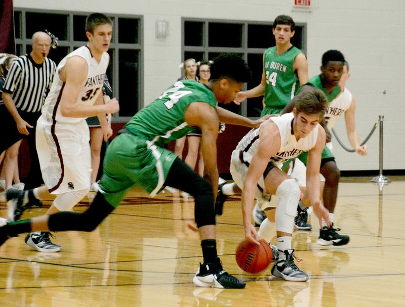 Graham Thomas/Siloam Sunday Van Buren senior Mitchell Smith and Siloam Springs junior Noah Karp battle for a loose ball during Tuesday&#8217;s game at Panther Activity Center. Van Buren defeated the Panthers 54-42 in a 7A/6A-Central Conference matchup.