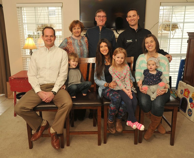 Montserrat Flores, (center front) exchange student from Chile, sits with her exchange family (back from left) Becky Brothers, Rob Brothers, Zach Brothers (front from left) Travis Creed, Ethan Creed, 3, Aubrey Creed, 5, Katie Creed and Eleanor Creed, 1, on Wednesday at the Creeds’ home in Lowell. The Creed and Brothers families have hosted relatives of Flores for the past three generations.