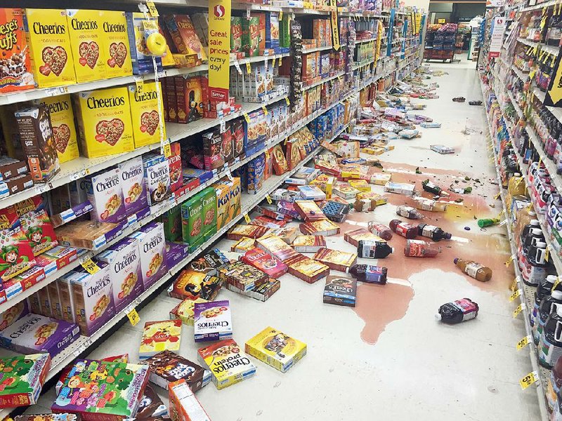 Boxes of cereal and bottles of juice lie on the floor of a Safeway grocery store Sunday after a magnitude- 7.1 earthquake on the Kenai Peninsula in south-central Alaska.