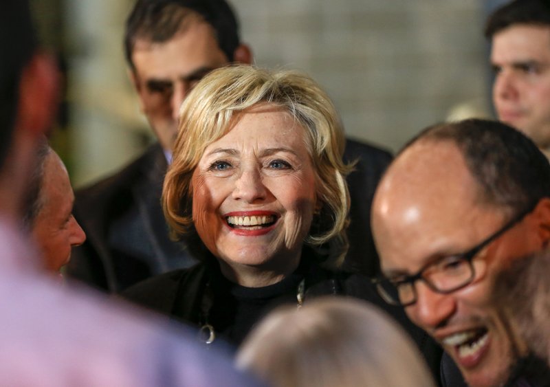 Democratic presidential candidate Hillary Clinton and Labor Secretary Tom Perez, right, meet members of the audience following a Clinton campaign stop in Sioux City, Iowa. 