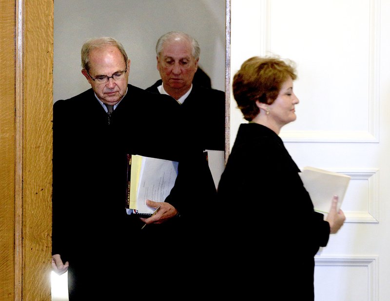 Arkansas Supreme Court Justice Karen Baker (right), Chief Justice Howard Brill and Justice Paul Danielson (rear) enter the Old Supreme Court Chamber at the state Capitol in September to begin the 2015 term’s first oral arguments.