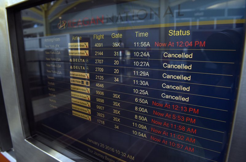 A flight status display monitor is seen at Washington's Ronald Reagan National Airport, Monday, Jan. 25, 2016. Flights remained delayed or canceled in the aftermath of a massive weekend blizzard that slammed into the eastern U.S., wreaking havoc on travel in the nation’s busiest cities, with airports in the New York City and Washington D.C. metro areas were the hardest hit. (AP Photo/Susan Walsh)
