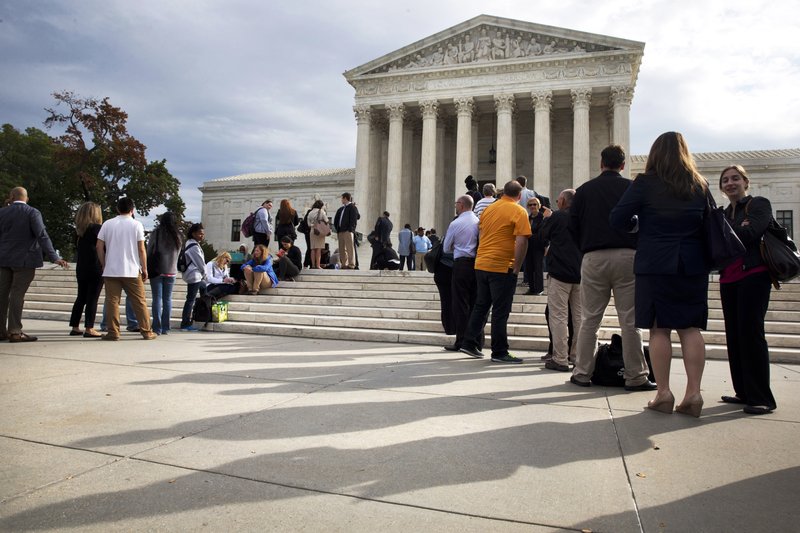 People line up outside of the Supreme Court in Washington, Tuesday, Oct. 13, 2015, as the justices began to discuss sentences for young prison 'lifers.'  