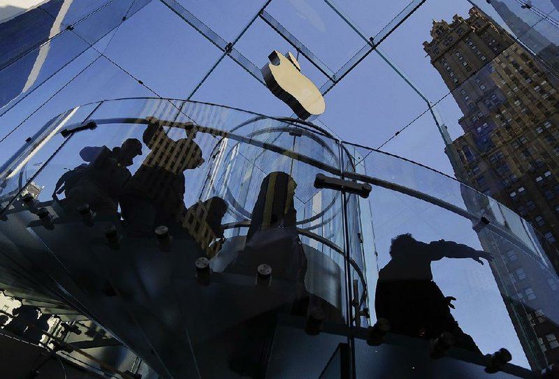 Visitors to an Apple store in New York descend a staircase to the showroom below in September. 
