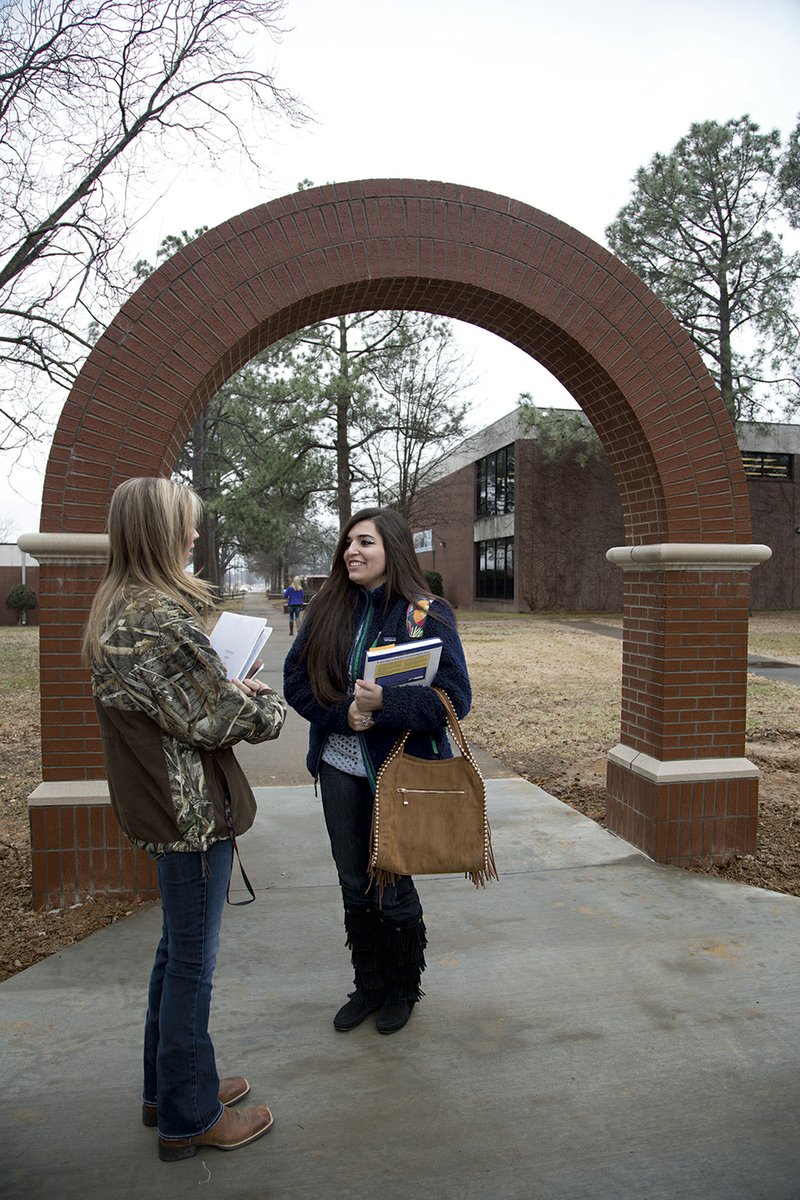 Sophomores Loren Marks, left, and Ashley Gentry walk to their classes through the newly constructed arch at Arkansas State University-Beebe.