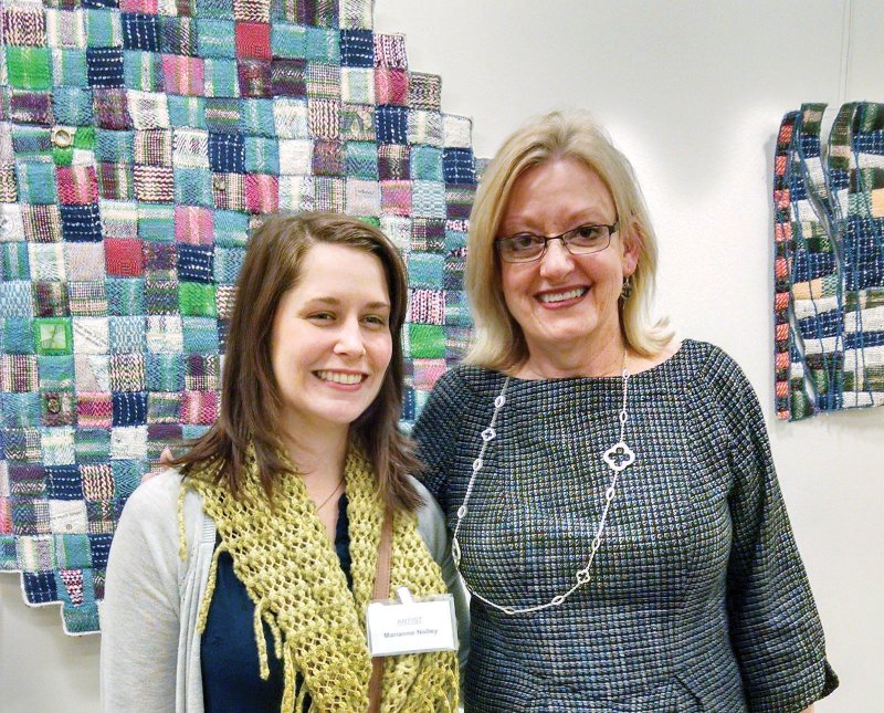 Deborah Kuster of Conway, right, professor of art at the University of Central Arkansas in Conway, poses with former student Marianne Nolley of Little Rock at the opening reception for Form in Fiber: A Nine-Woman Fiber Arts Show at the Argenta Branch of the William F. Laman Library System in North Little Rock. Kuster and Nolley both have works in the show, which will close Feb. 5.