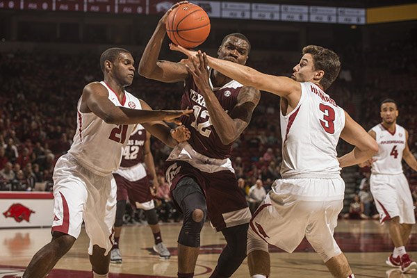 Dusty Hannahs (3) Arkansas junior guard and Manuale Watkins (21) Arkansas junior guard harass Jalen Jones, Texas A&M senior guard Wednesday, Jan. 27, 2016 in the first half at Bud Walton Arena in Fayetteville.