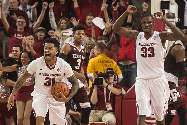 Anton Beard (31) Arkansas sophomore guard and Moses Kingsley (33) Arkansas junior forward celebrate as time expires against Texas A&M Wednesday, Jan. 27, 2016 at Bud Walton Arena in Fayetteville. The Razorbacks won 74-71.