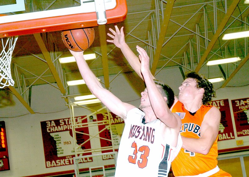 PHOTO BY RICK PECK McDonald County&#8217;s Daton Aburey gets past Republic&#8217;s Tristan Ollar for two of his 18 points during the Mustangs&#x2019; 50-42 loss Friday night at MCHS.