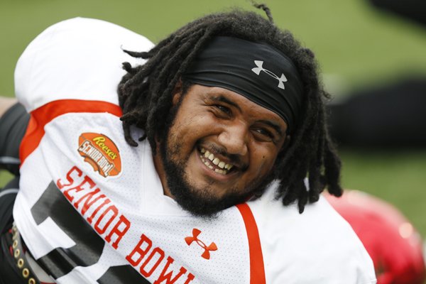 Arkansas offensive guard Sebastian Tretola smiles during stretching at the NCAA college football practice for the Senior Bowl, Wednesday, Jan. 27, 2016, at Ladd–Peebles Stadium, in Mobile, Ala. (AP Photo/Brynn Anderson)