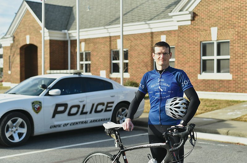 Capt. Jeremy Crabb, an officer with the University of Central Arkansas Police Department in Conway, stands with his bicycle, which he will ride 545 miles in the AIDS LifeCycle race in June in California. Crabb is trying to raise $5,000 before he leaves, and donations may be made to tiny.cc/jcrabb.