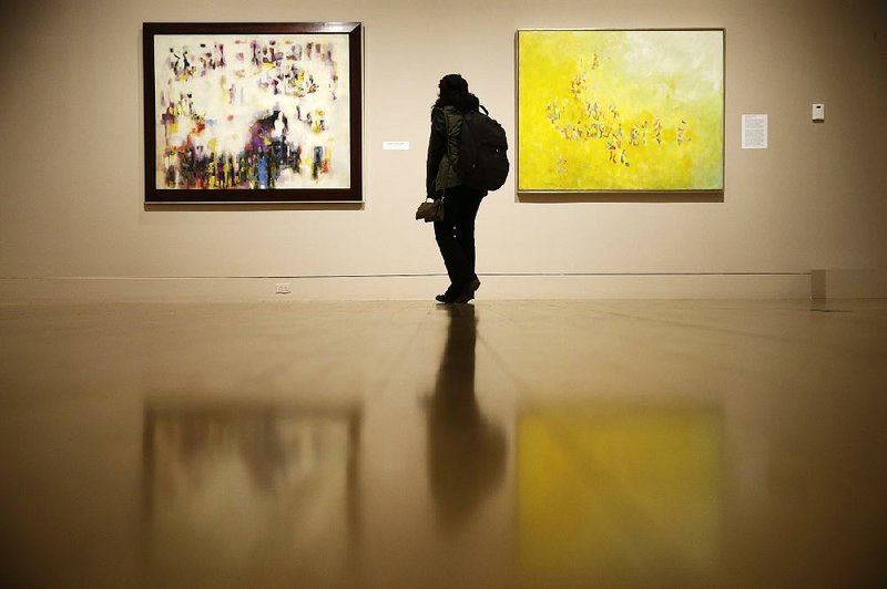 A woman views “Procession: The Art of Norman Lewis” in December. Lewis was the first major black abstract expressionist.