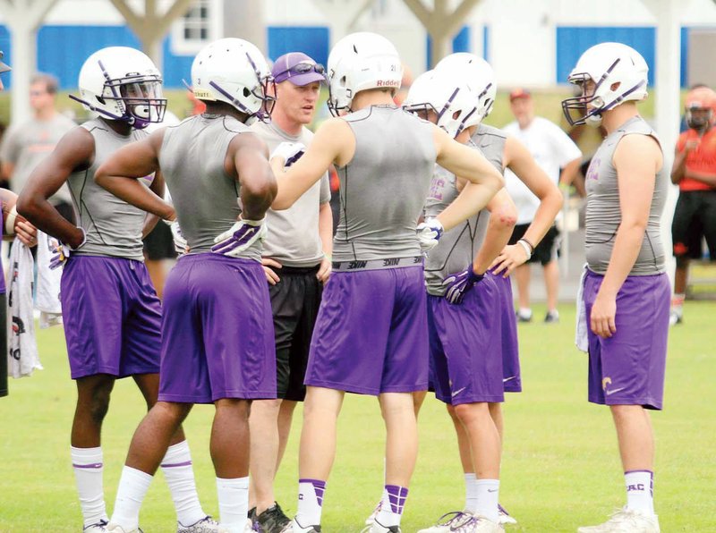 Central Arkansas Christian football coach Tommy Shoemaker, center, talks to his offense during a 7-on-7 tournament last summer. Shoemaker is the 2015 River Valley & Ozark Edition Coach of the Year.  The complete all-area team is on pages 6V and 7V.