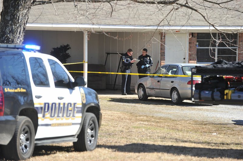 Fayetteville police officers investigate a crime scene Friday at a duplex at 764 N 54th Street in Fayetteville. Alfred Davis Matthews Jr. died after a stabbing incident involving his brother, Freddie Davis Matthews.