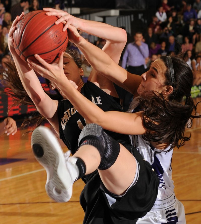 Lauren Hargus (left) of Bentonville and Haley Ratcliff of Fayetteville tie up a loose ball Fridayduring the second half at Bulldog Arena in Fayetteville. Visit nwadg.com/photos to see more photographs from the game.