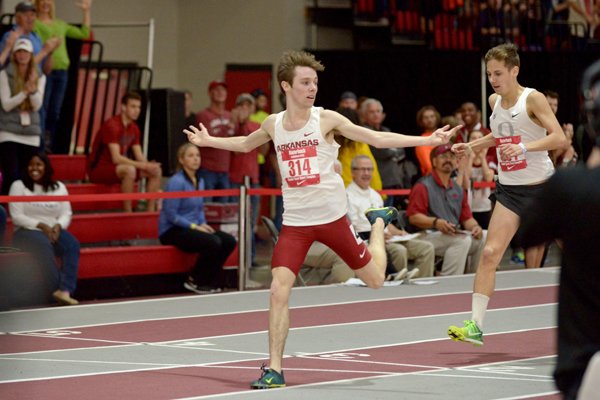 Alex George of Arkansas celebrates as he edges out Jake Leingang of Oregon to win the 3000 meter invitational on Saturday Jan. 30, 2016 during the Razorback Invitational indoor track meet in the Randal Tyson Track Complex in Fayetteville. George won the event with a time of 8:09.79 minutes. 