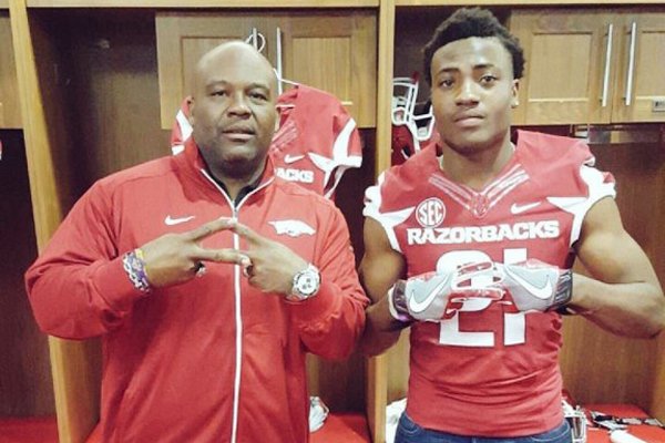 Marshall, Texas, safety Micahh Smith, pictured here with Arkansas defensive backs coach Clay Jennings, committed to the Razorbacks Saturday, Jan. 30, 2016.