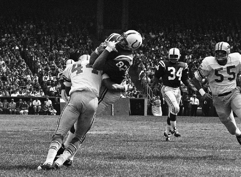 Raymond Berry (82, above) caught a lot of passes from Johnny Unitas in his career, and one from the 1958 NFL Championship Game is being auctioned off.