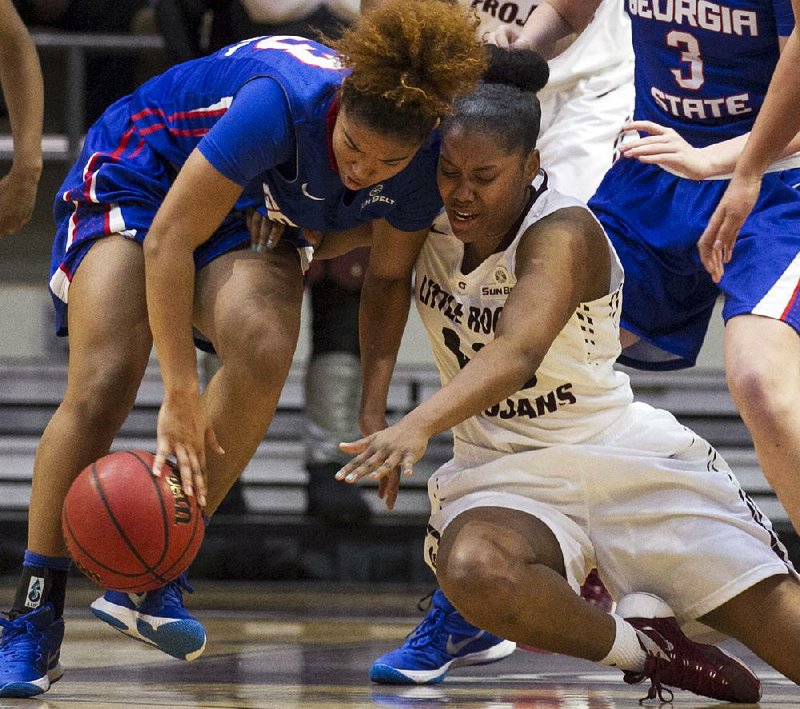 UALR’s Kaitlyn Pratt (right) and Georgia State’s Madison Newby battle for a loose ball during the Trojans’ 59-32 victory over the Panthers on Saturday at the Jack Stephens Center.