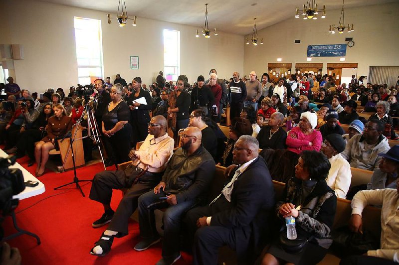 During a packed public meeting Saturday in Flint, Mich., residents line up at a microphone to ask questions about their legal rights in regard to the city’s water crisis.  