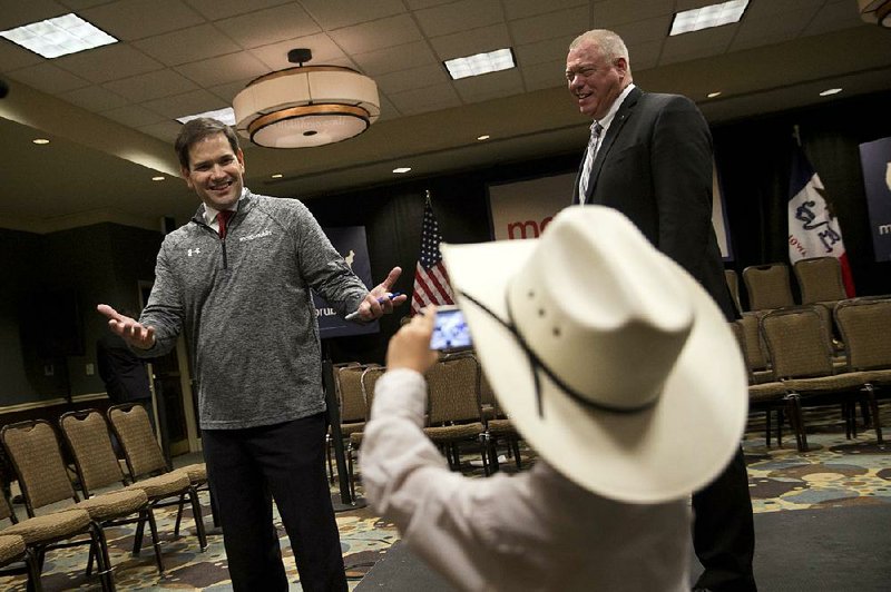 McCoy Wicker, 5, takes pictures of Republican presidential candidate Marco Rubio after a rally Saturday in Council Bluffs, Iowa. 