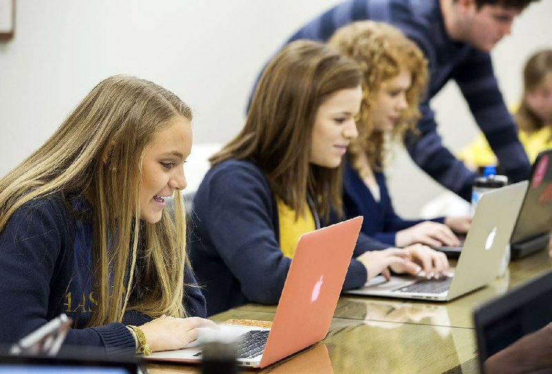 Alexis Hodne, a freshman at Haas Hall Academy, works Friday in her computer business applications class on the Fayetteville campus. The school is hoping to expand to a Springdale campus in the Jones Center. 