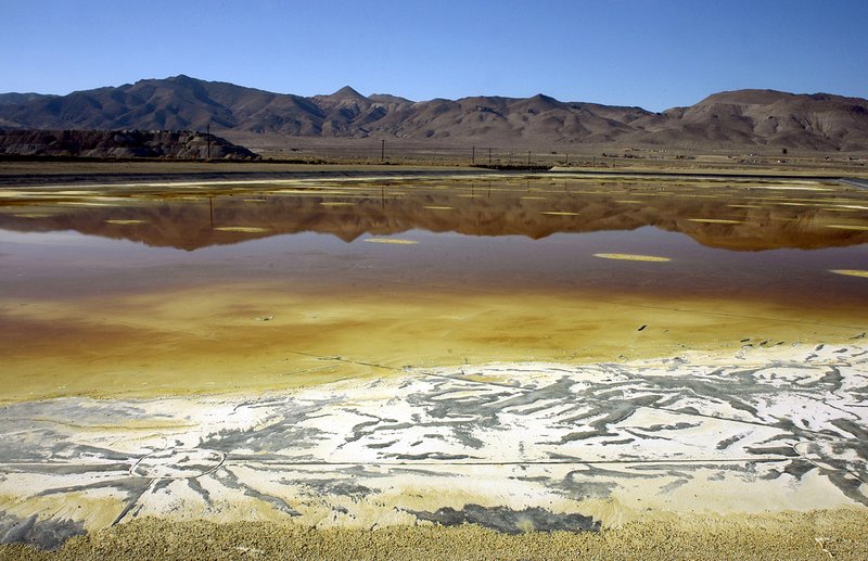  In this Nov. 30, 2004 file photo, an evaporation pond holds contaminated fluid and sediment at the former Anaconda copper mine near Yerington, Nev.