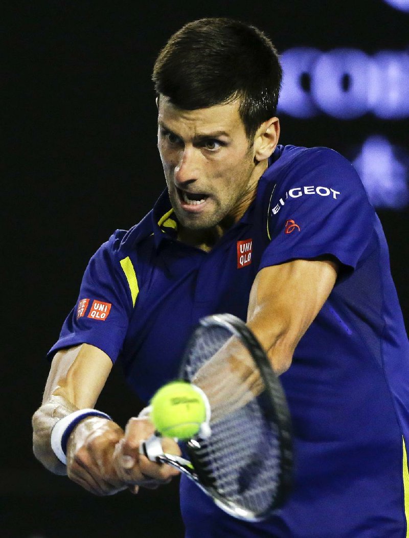 Novak Djokovic of Serbia plays a backhand return to Andy Murray of Britain during the men’s singles final Sunday at the Australian Open in Melbourne. Djokovic beat Murray 6-1, 7-5, 7-6 (3) to claim his sixth Australian Open and third consecutive Grand Slam title.