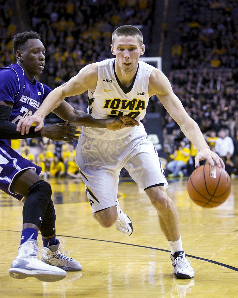 Iowa forward Jarrod Uthoff (right) drives past Northwestern guard Scottie Lindsey during the second half of Sunday’s game. Uthoff scored 23 points in the Hawkeyes’ 85-71 victory.