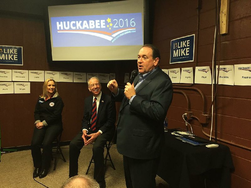 After comments by Arkansas Attorney General Leslie Rutledge (from left) and U.S. Sen. Charles Grassley, R-Iowa, former Arkansas Gov. Mike Huckabee urged a West Des Moines, Iowa, audience on Sunday afternoon to attend today’s Republican caucuses.