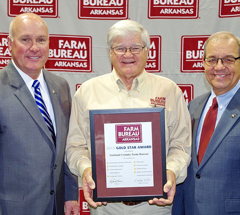 Submitted photo Garland County Farm Bureau board member Melvin Daniel, center, of Hot Springs received recognition for the county's work at the 81st Arkansas Farm Bureau annual convention in Little Rock. Presenting the award were Randy Veach, right, president, and Rich Hillman, vice president, of Arkansas Farm Bureau. Each county Farm Bureau is measured in 10 program areas and awarded Gold Stars for exemplary effort in each one. Garland County earned eight Gold Stars. Arkansas Farm Bureau is a nonprofit, private farm and rural advocacy organization of more than 190,000 families throughout the state working to improve farm and rural life.