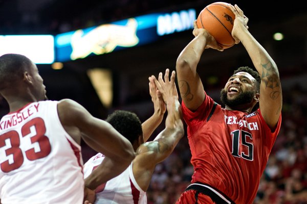 Texas Tech's Aaron Ross (15) shoots a basket over Arkansas' Athlon Bell (5) and Moses Kingsley (33) in the second half of an NCAA college basketball game against Texas Tech in Fayetteville, Ark., Saturday, Jan. 30, 2016. Arkansas won 75-68. (AP Photo/Sarah Bentham)