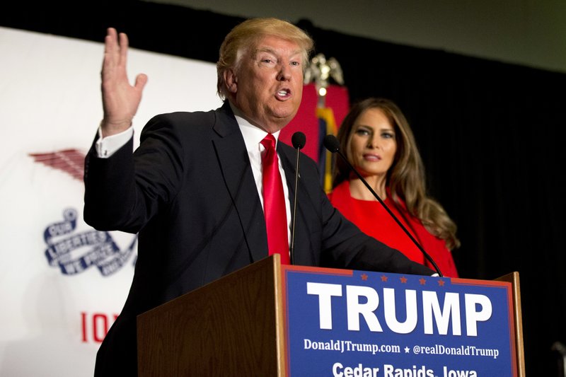 Republican presidential candidate Donald Trump is joined by his wife Melania Trump as speaks during a campaign event, Monday, Feb. 1, 2016, in Cedar Rapids, Iowa. (AP Photo/Mary Altaffer)