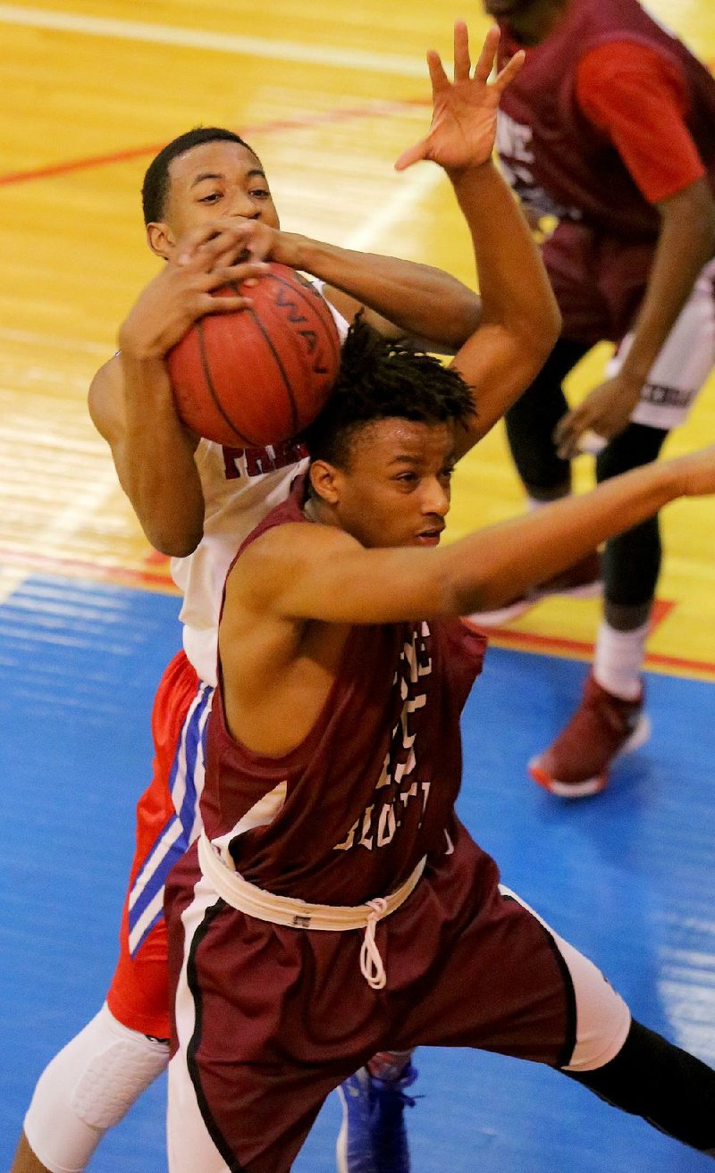 Little Rock Parkview’s Rod Terry (top) pulls down a rebound in front of Pine Bluff’s Trey Williams during the Patriots’ 69-45 victory over the Zebras on Tuesday in Little Rock.