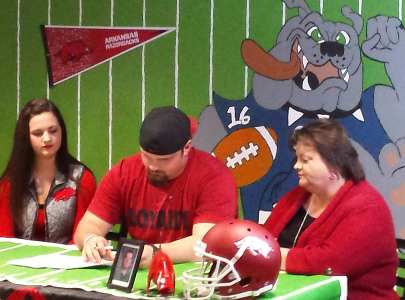  Star City defensive lineman Austin Capps is joined by his sister Mary Katherine and his mother Thea on Wednesday as he signs his National Letter of Intent with the University of Arkansas. 