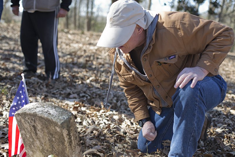 Mike Kish, president of the Reed’s Bridge Battlefield Preservation Society, looks at a grave marker at the McCraw Cemetery in Jacksonville. Kish and other society members recently heard from an archaeologist that there may be a potter’s field next to the cemetery’s border.