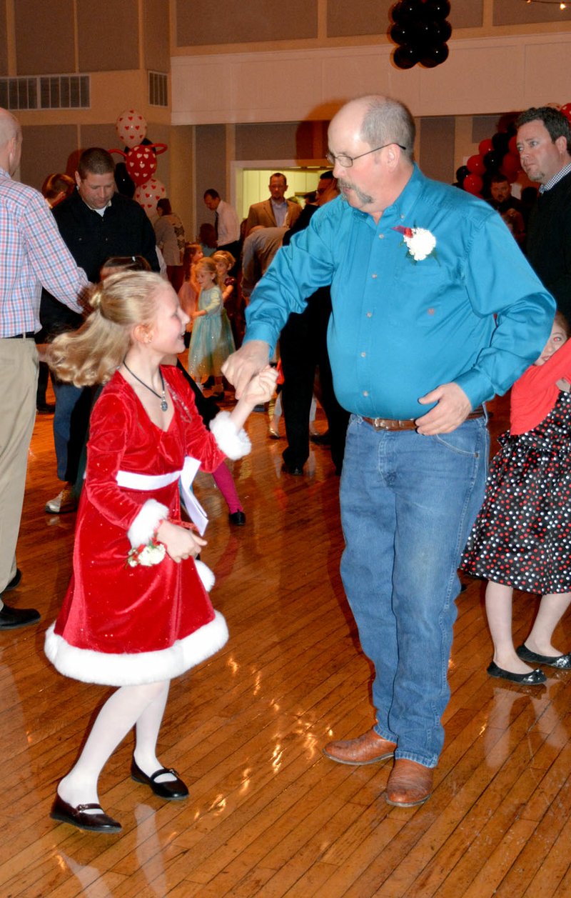 File photo A father twirled his daughter on the dance floor during the 2015 Daddy Daughter Dance.