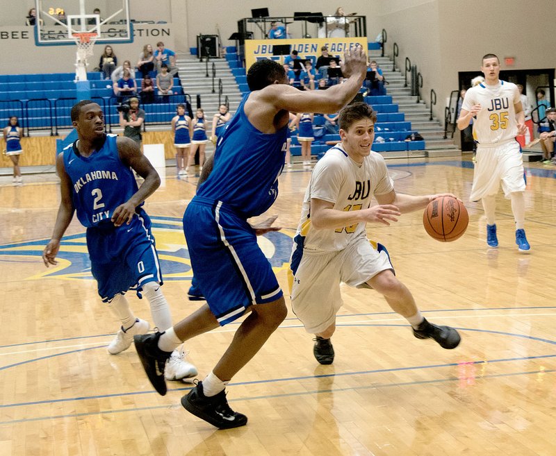 Photo courtesy of JBU Sports Information John Brown senior guard Luke Moyer drives to the basket Saturday against Oklahoma City at Bill George Arena. The Stars defeated the Golden Eagles 76-67.