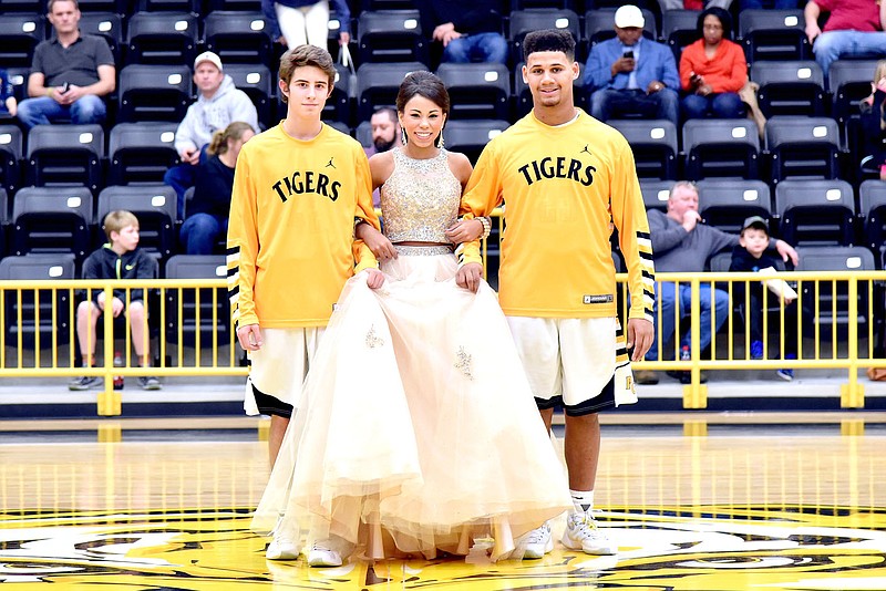 Photo by Shelley Williams/Freshman maid Larish Crawford was escorted by Diego Iglesias (left) and Demarcus Cooper.