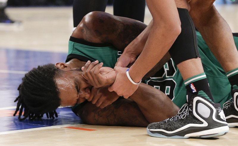 Boston Celtics forward Jae Crowder (99) grimaces after taking an elbow to his face from New York Knicks forward Carmelo Anthony during the first quarter of an NBA basketball game, Tuesday, Feb. 2, 2016, in New York. Anthony was called with a flagrant foul on the play. 