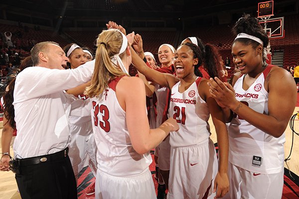 Arkansas coach Jimmy Dykes (left) celebrates with Melissa Wolff (33), Devin Cosper (21) and Khadijah West (right) after Arkansas' 64-59 win over Tennessee Thursday, Jan. 14, 2016, in Bud Walton Arena in Fayetteville. 