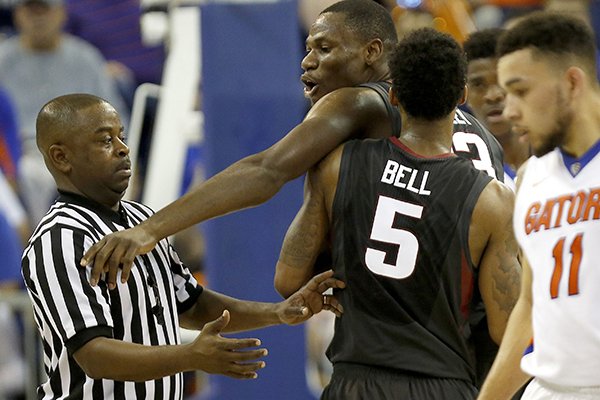 Arkansas guard Anthlon Bell (5) holds back forward Moses Kingsley (33) after Kingsley was called for a technical foul against Florida during the second half of an NCAA college basketball game at the O'Connell Center on Wednesday, Feb. 3, 2016 in Gainesville, Fla. Florida defeated Arkansas 87-83. (Matt Stamey/The Gainesville Sun via AP)