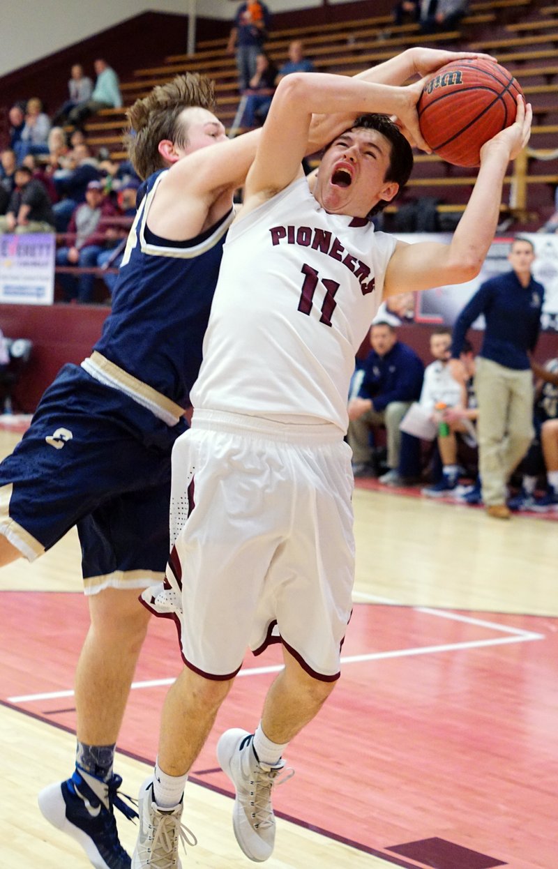 Wyatt Clark, Gentry senior, is fouled by Reagan Neal, sophomore from Shiloh Christian, during play between the two teams in Gentry on Feb. 2, 2016.