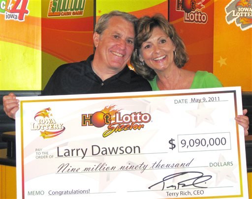 This May 9, 2011, photo provided by the Iowa Lottery shows Larry Dawson and his wife, Kathy, claiming their $9.09 million Hot Lotto jackpot in Des Moines.